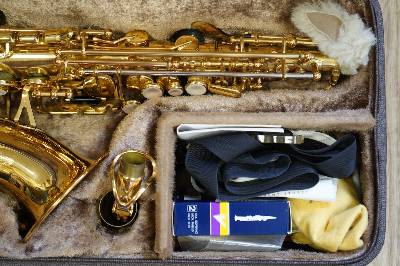 A cased Yanagisawa brass soprano saxophone with engraved decoration. Condition - good